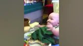 Baby laughing at old cartoon cup
